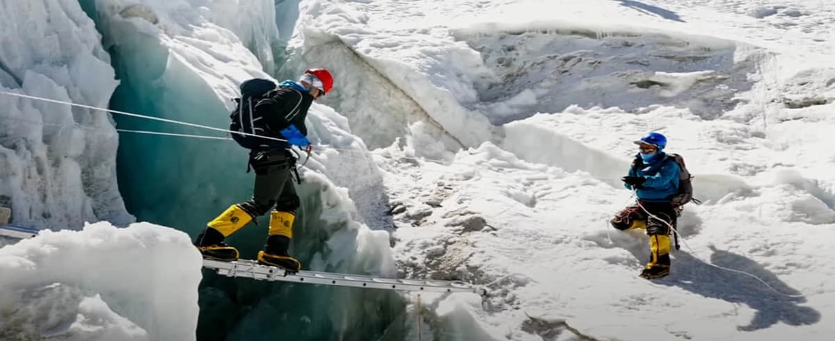 island-peak-glacier-crevasse-crossing Climbers roped up crossing a crevasse on the Island Peak glacier route