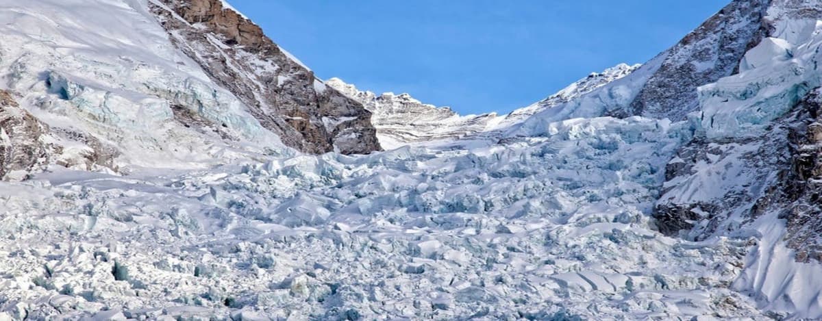 verest-base-camp-khumbu-glacier-trail Trekkers crossing the rocky moraine of the Khumbu Glacier on the way to Everest Base Camp